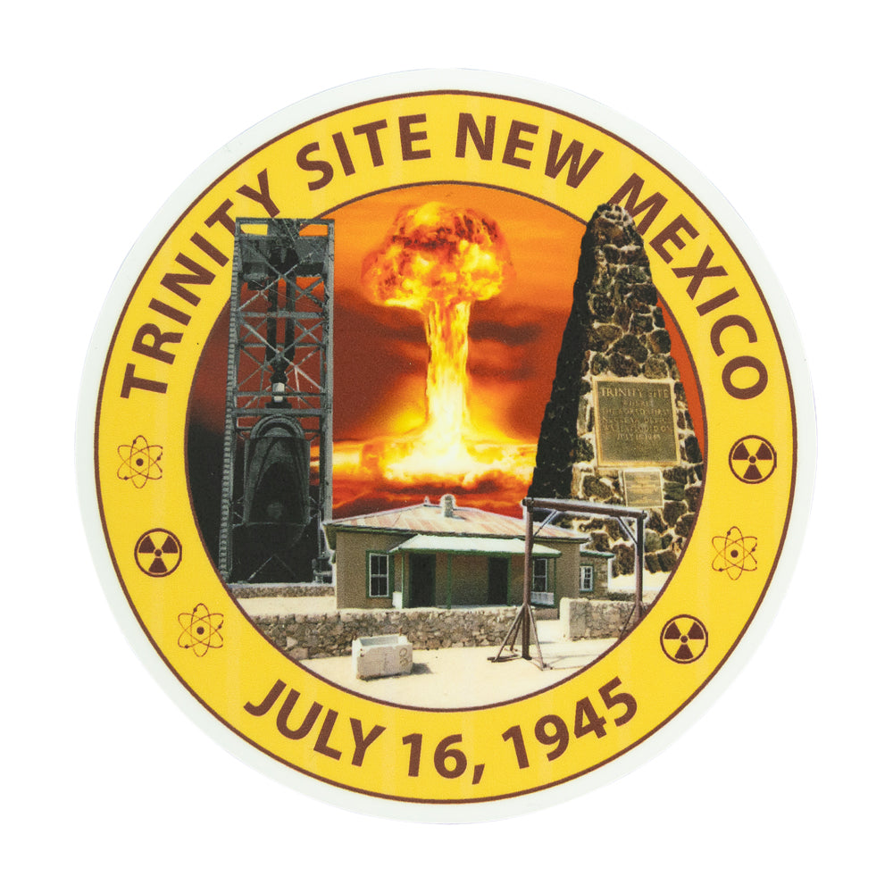 A circular commemorative  sticker for Trinity Site New Mexico, featuring a nuclear explosion mushroom cloud, a radiation symbol, a small building, and the text &
