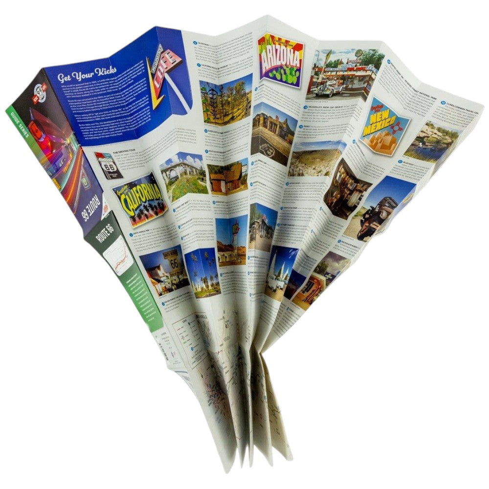 A folded paper map opened to show multiple printed pages with colorful travel imagery and text, photographed on a plain white background.