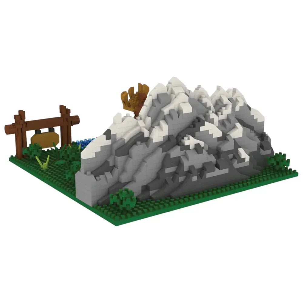 Interlocking brick set of a mountain with a wooden structure on a white background