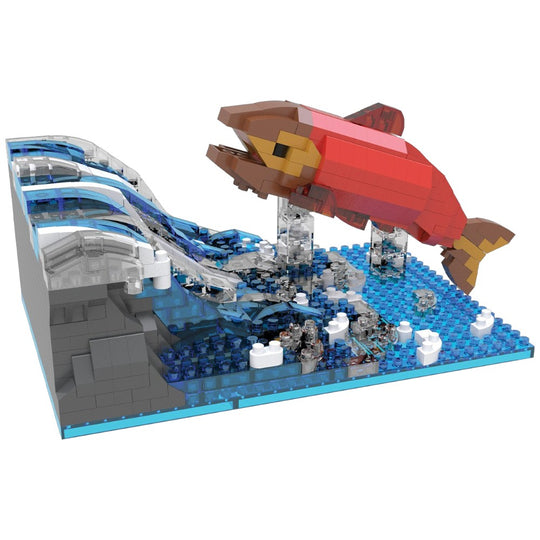 Model of a salmon leaping over a waterfall made from interlocking bricks on a white background