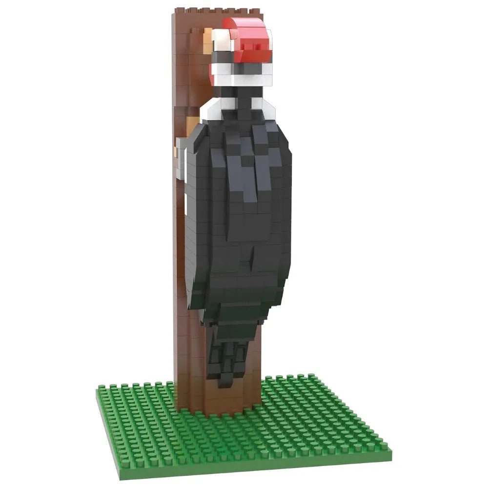 Toy figure of a bird on a stand with a green baseplate on a white background