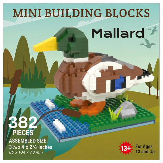 Box-style product graphic for a Mallard duck building block set. The image shows an assembled duck model made from mini building blocks on a blue base with green grass, a gray rock, and a brown reed, with text reading &