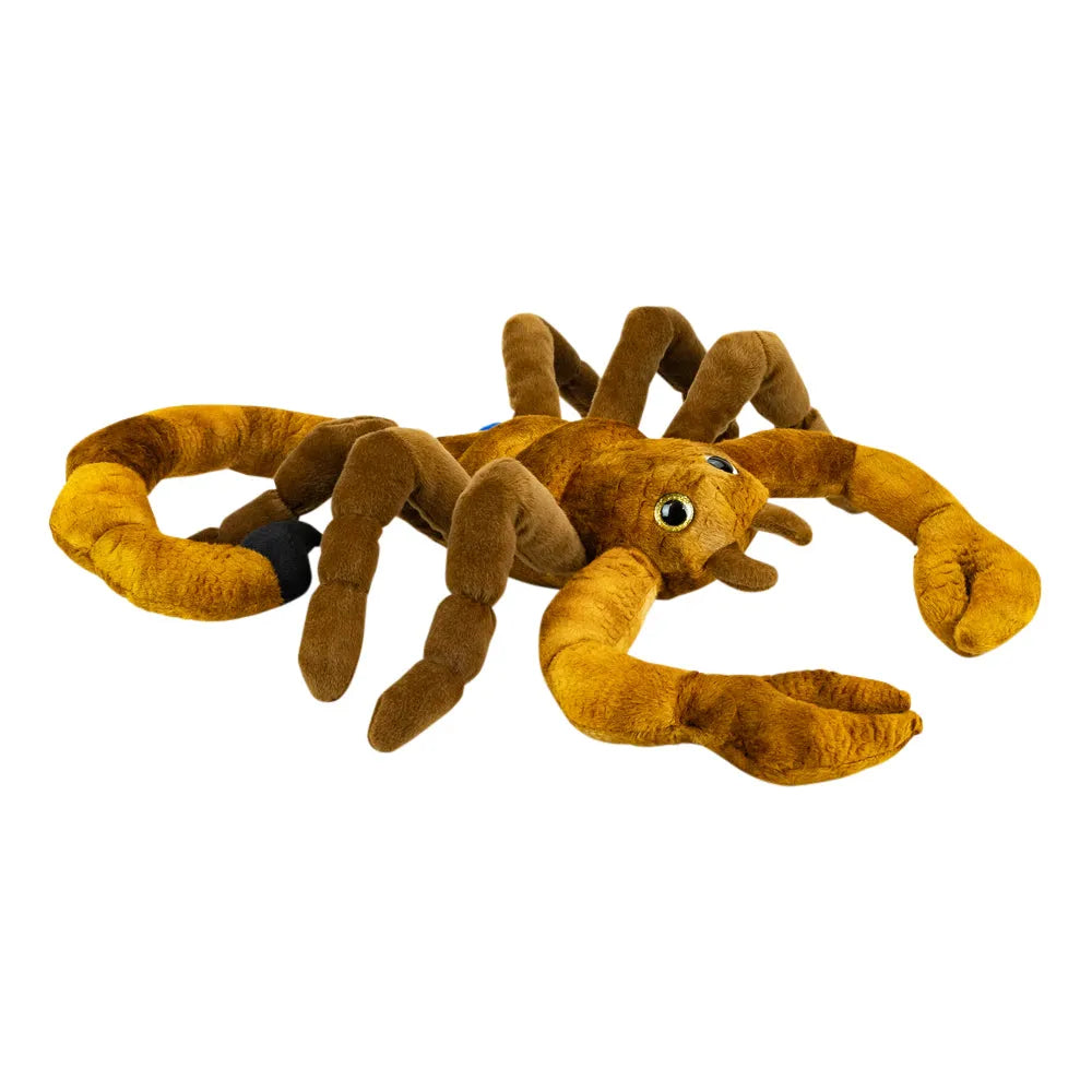 A plush scorpion toy in shades of brown and golden brown, featuring large green eyes and a small black accent on one leg, isolated on a white background.