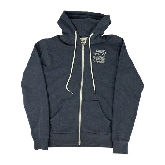 A dark heather gray zip-up hoodie with cream-colored drawstrings and a zipper, featuring a small embroidered shield logo on the left chest, displayed against a solid white background.