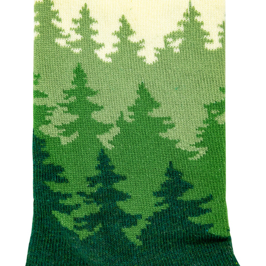 A close-up of a knit sock featuring a green pine forest pattern with a cream-colored top section, set against a plain white background.