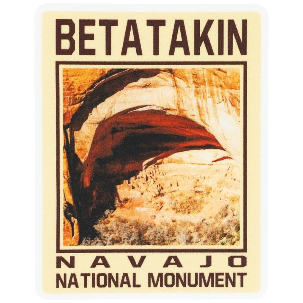 A vintage-style sticker reading "BETATAKIN" at the top ,"NAVAJO NATIONAL MONUMENT" at the bottom, and a photograph of the cliff dwelling in the center.