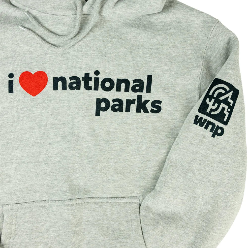 Close-up of a light heather gray hoodie with black text reading &