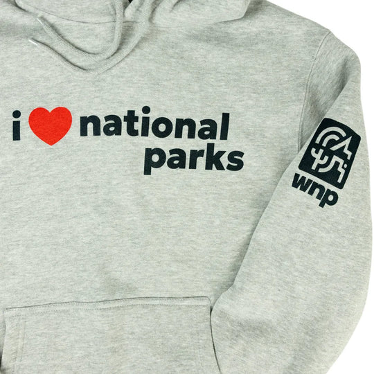 Close-up of a light heather gray hoodie with black text reading &