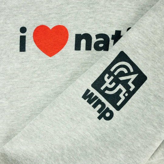 Close-up of a light heather gray fabric garment with a printed slogan reading &