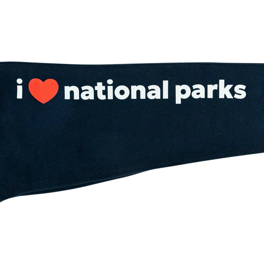 A close-up of a dark navy blue fabric item, featuring the white text &