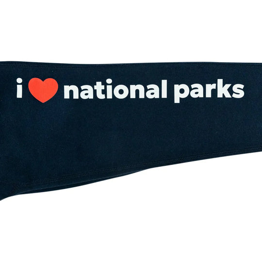 A close-up of a dark navy blue fabric item, featuring the white text &