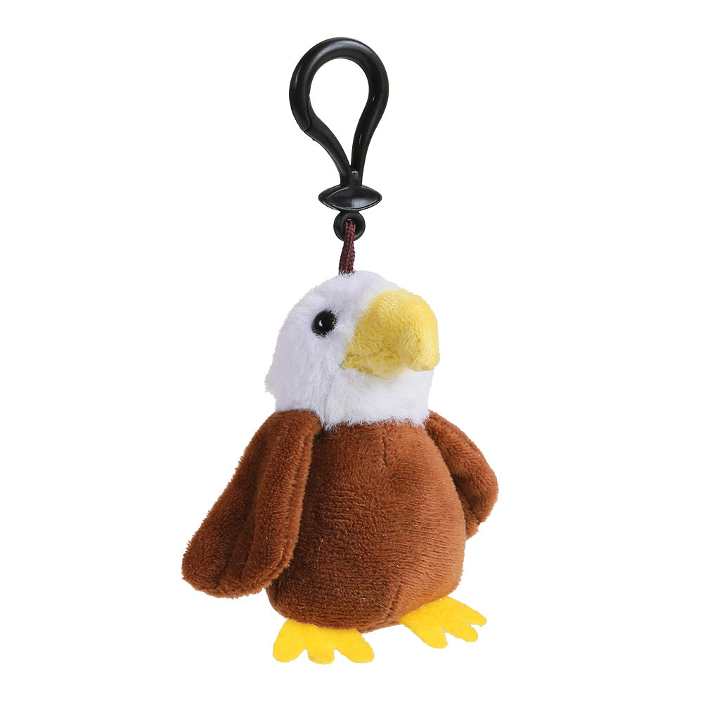 A plush eagle keychain or bag charm with a brown body, white head, yellow beak and feet, attached to a black plastic clip on a white background.