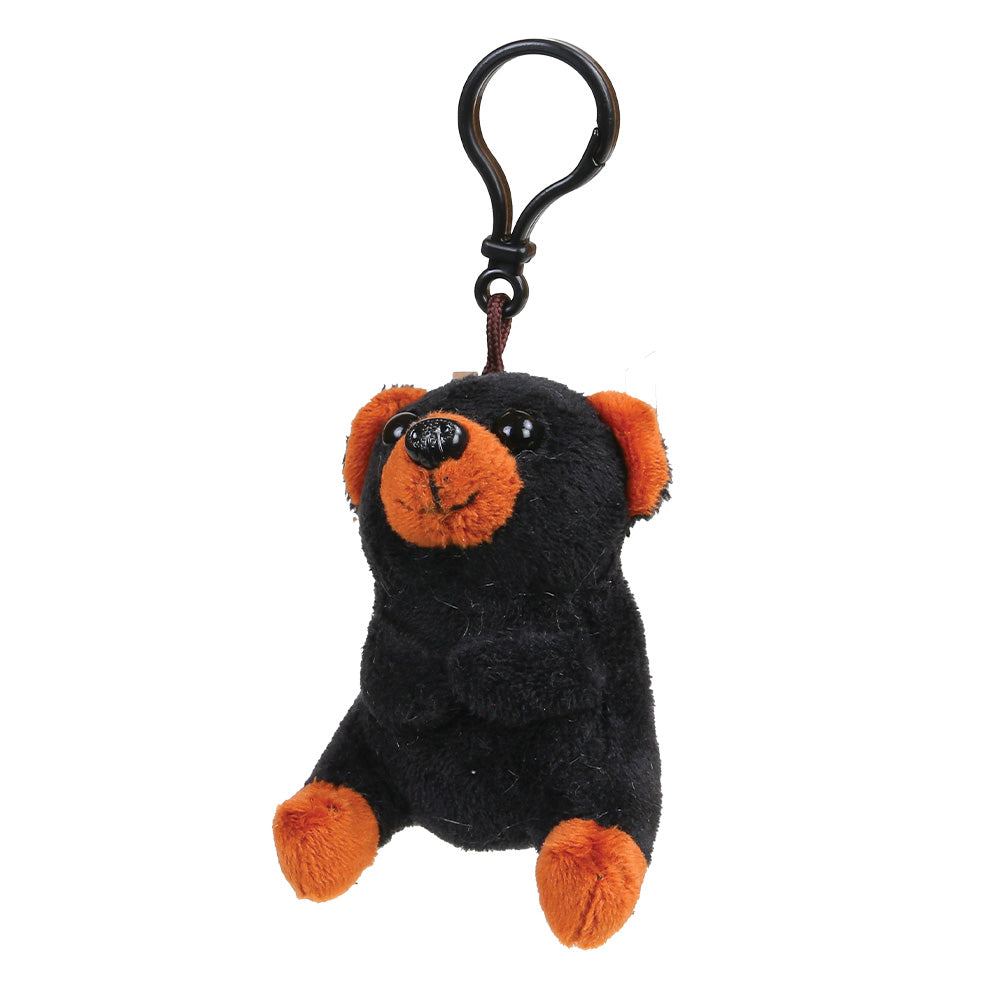 A small plush black bear keychain in black with orange accents on its ears, snout, and paws, attached to a black metal carabiner clip, shown against a plain white background.