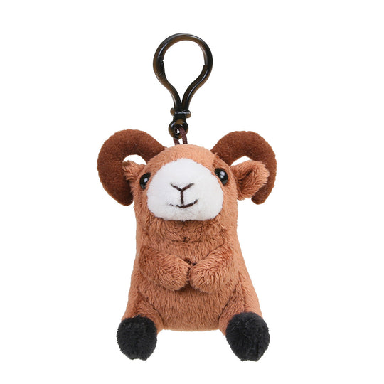 A brown plush ram keychain with curved horns, a white snout and face, black embroidered details, and black pom-pom feet, attached to a black metal key ring on a plain white background.