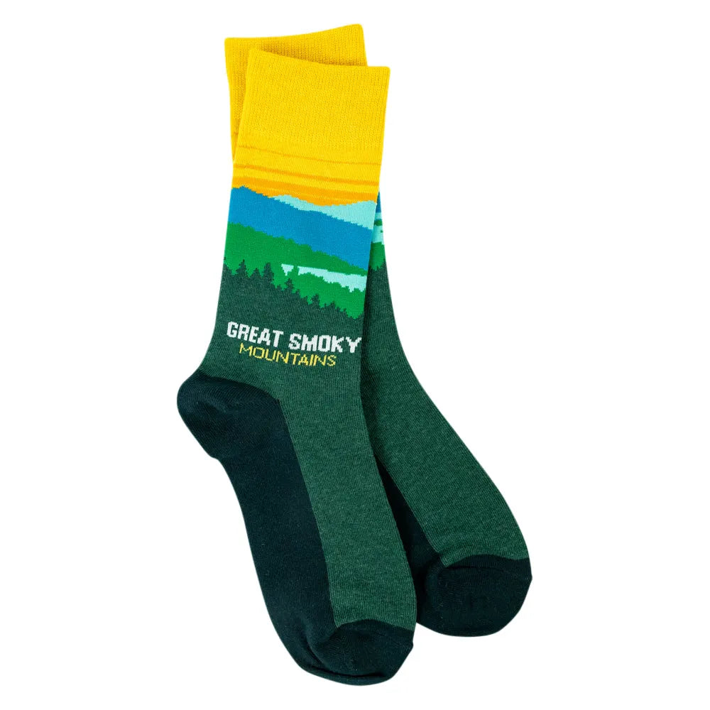 A pair of crew socks featuring a scenic mountain landscape print with the text &
