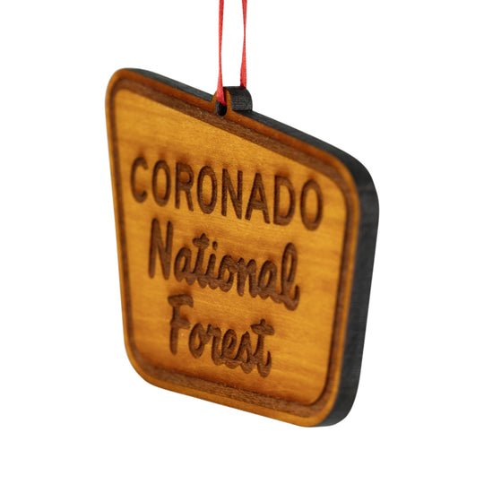 A trapezoidal wooden hanging ornament engraved with &