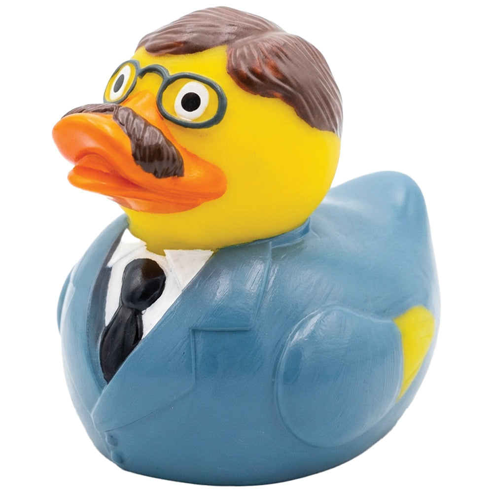 A novelty rubber duck designed to look like Teddy Roosevelt wearing a blue suit, white shirt, black tie, brown hair, and glasses, isolated on a white background.