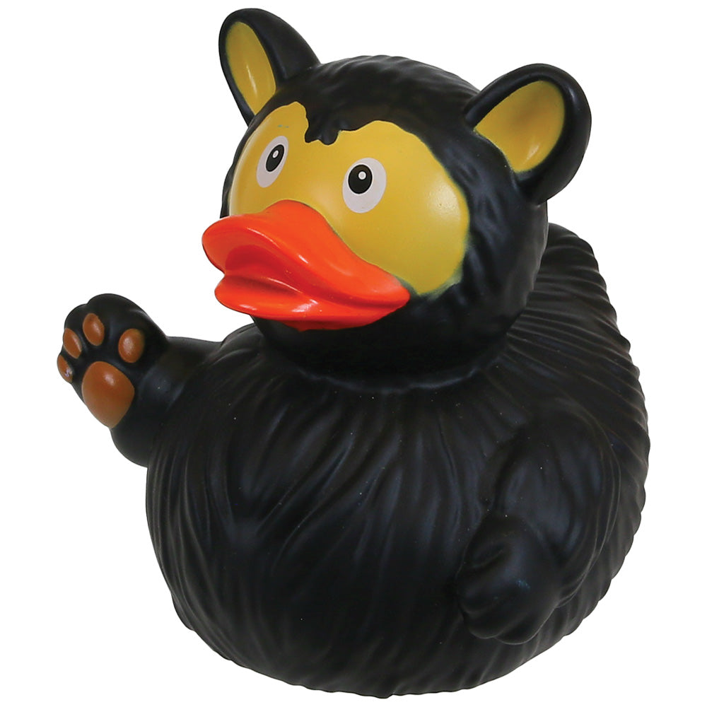 A black rubber duck shaped like a bear, featuring a yellow face, orange beak, and raised paw with brown pads, isolated on a white background.