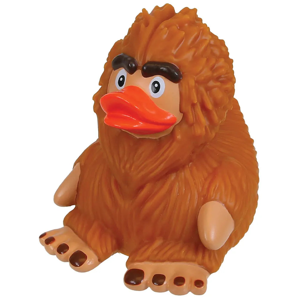 A novelty rubber toy of a brown furry creature with a duck-like orange beak, black eyebrows, and beige limbs, shown against a plain white background.