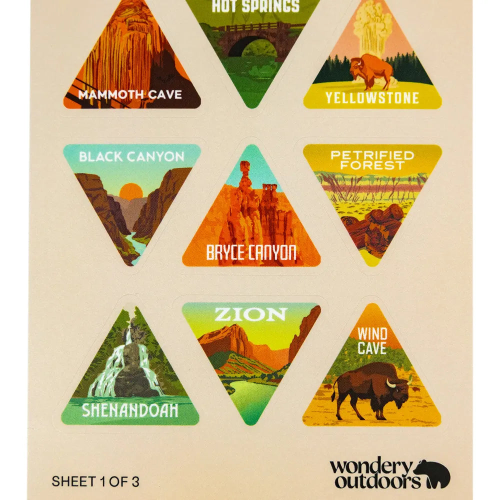 A sheet of triangular travel-style stickers featuring labeled desert and canyon landscapes: Mammoth Cave, Hot Springs, Yellowstone, Black Canyon, Petrified Forest, Bryce Canyon, Zion, Shenandoah, and Wind Cave. The sheet has a warm beige background and the brand name Wondery Outdoors at the bottom right.