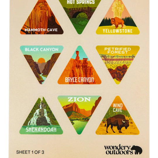 A sheet of triangular travel-style stickers featuring labeled desert and canyon landscapes: Mammoth Cave, Hot Springs, Yellowstone, Black Canyon, Petrified Forest, Bryce Canyon, Zion, Shenandoah, and Wind Cave. The sheet has a warm beige background and the brand name Wondery Outdoors at the bottom right.