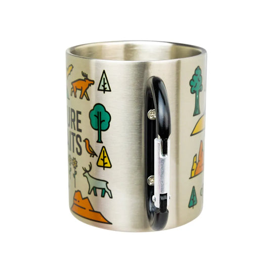 A brushed stainless steel mug with a black handle, decorated with colorful outdoor-themed illustrations including trees, a deer, a bird, and text.
