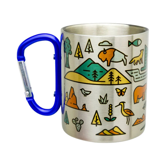 A stainless steel camping mug with a bright blue carabiner handle, decorated with colorful outdoor-themed illustrations including mountains, trees, a buffalo, a giraffe, and birds.