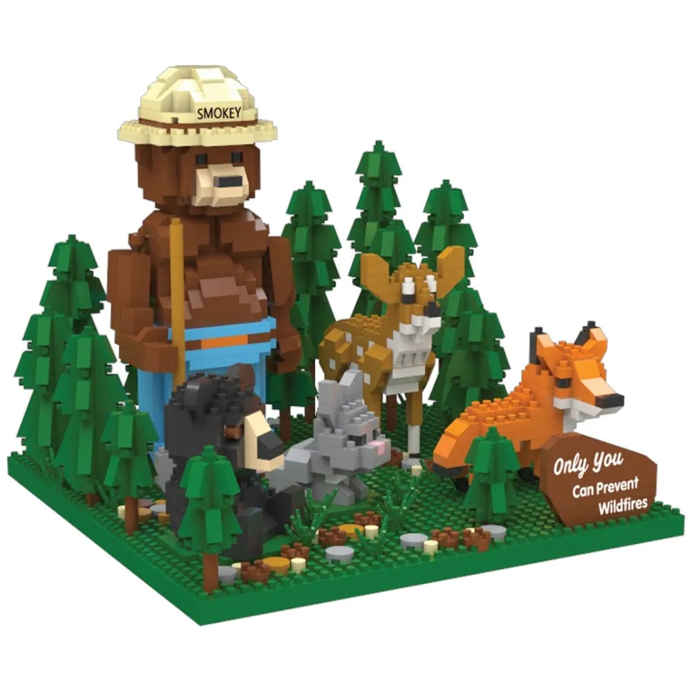 An side view of the Smokey Bear and Friends building block set. It features Smokey Bear with his ranger flat hat and shovel, standing in a forest with a deer, bear, rabbit, fox, and his slogan "Only You Can Prevent Wildfires." 