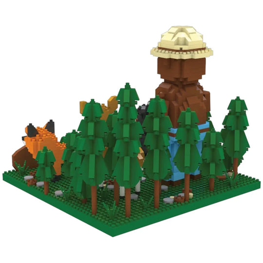 A view of the back of the Smokey Bear and Friends mini block set. It features Smokey Bear with his ranger flat hat and shovel, standing in a forest with a deer, bear, rabbit, fox, and his slogan "Only You Can Prevent Wildfires." 