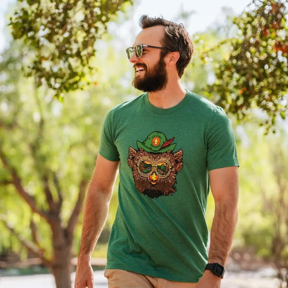 Man wearing a green t-shirt with Woodsy Owl on it. 