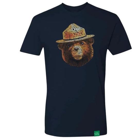 A navy blue short-sleeve t-shirt featuring a graphic of Smokey Bear wearing a flat cap, set against a plain white background