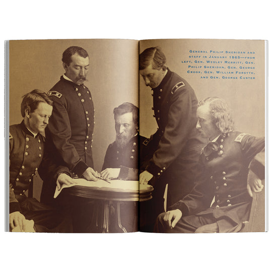 An open book showing a sepia-toned historical photograph of several military officers gathered around a table, with printed caption text on the right page.