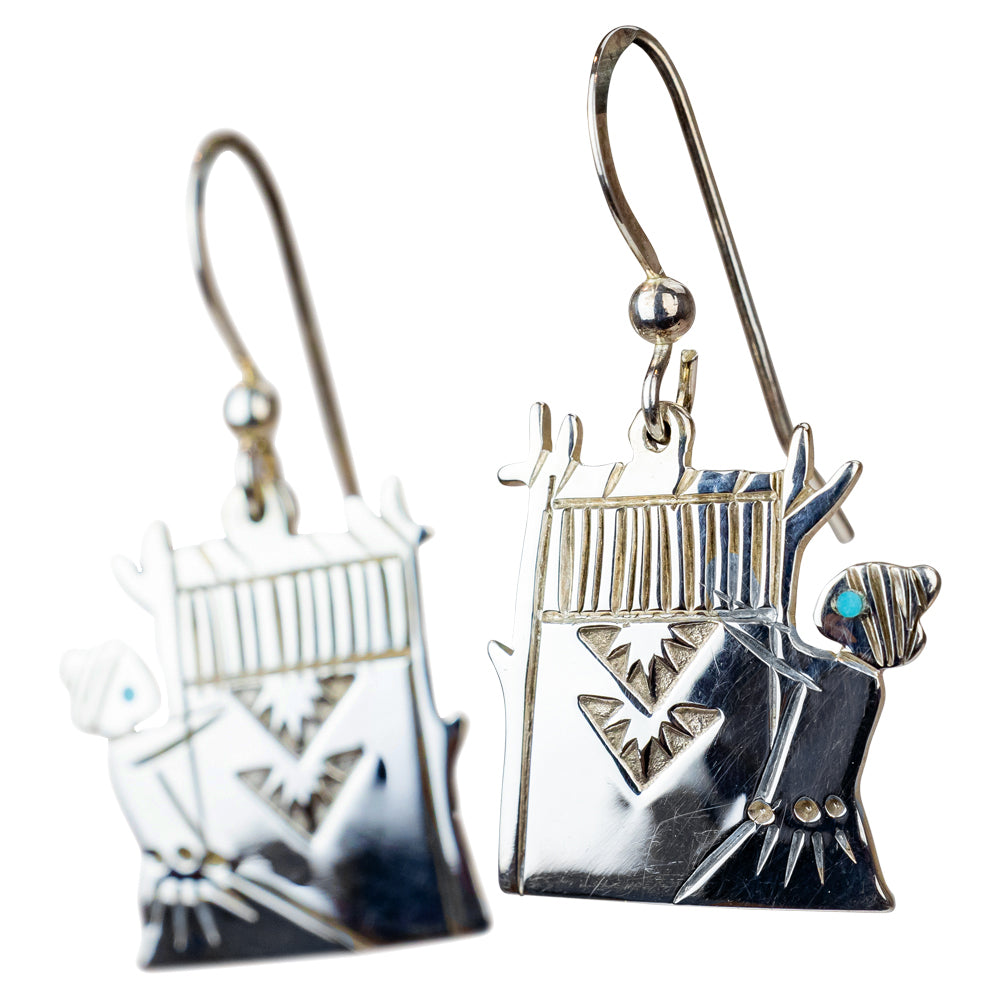 Silver earrings with intricate designs on a white background