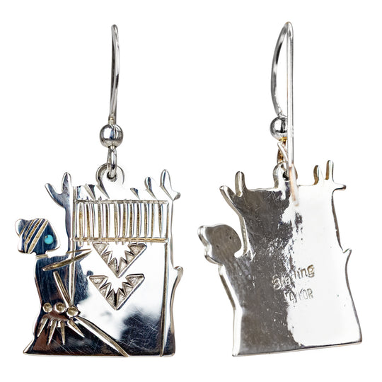 Pair of silver earrings with intricate designs on a white background