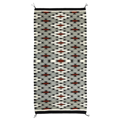 Navajo woven rug with geometric pattern on a white background