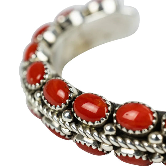 Close up of Navajo bracelet with coral stones on a white background