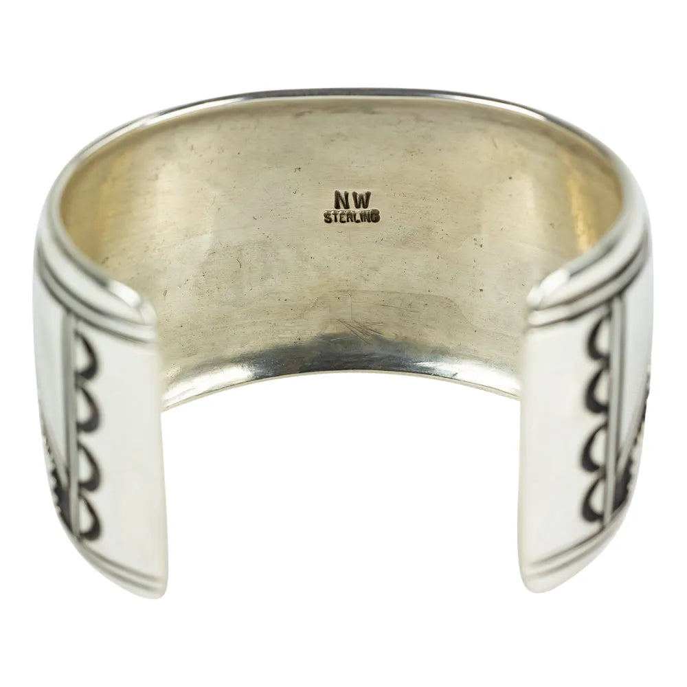 Silver cuff bracelet with 'NW' stamp on a white background