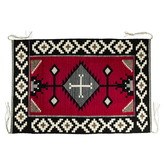 Handcrafter Navajo woven textile with geometric pattern on a red background