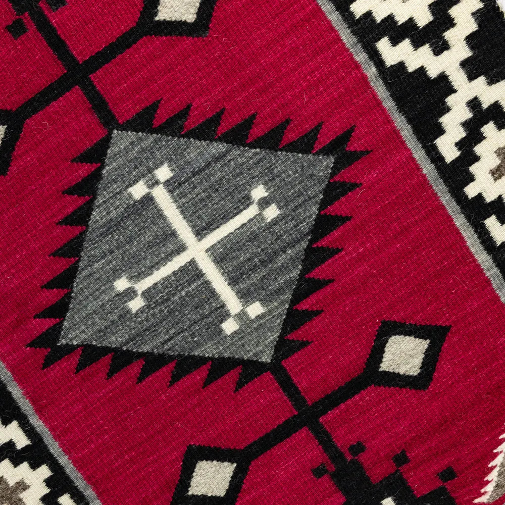 Close-up of a patterned fabric with geometric design on a red background