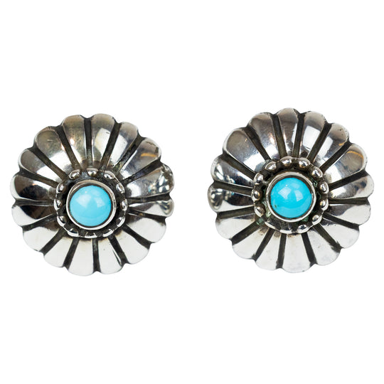 Pair of silver earrings with turquoise stones on a white background