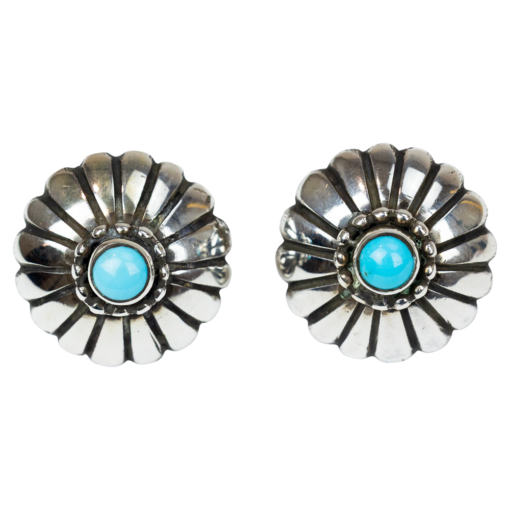 Pair of silver earrings with turquoise stones on a white background