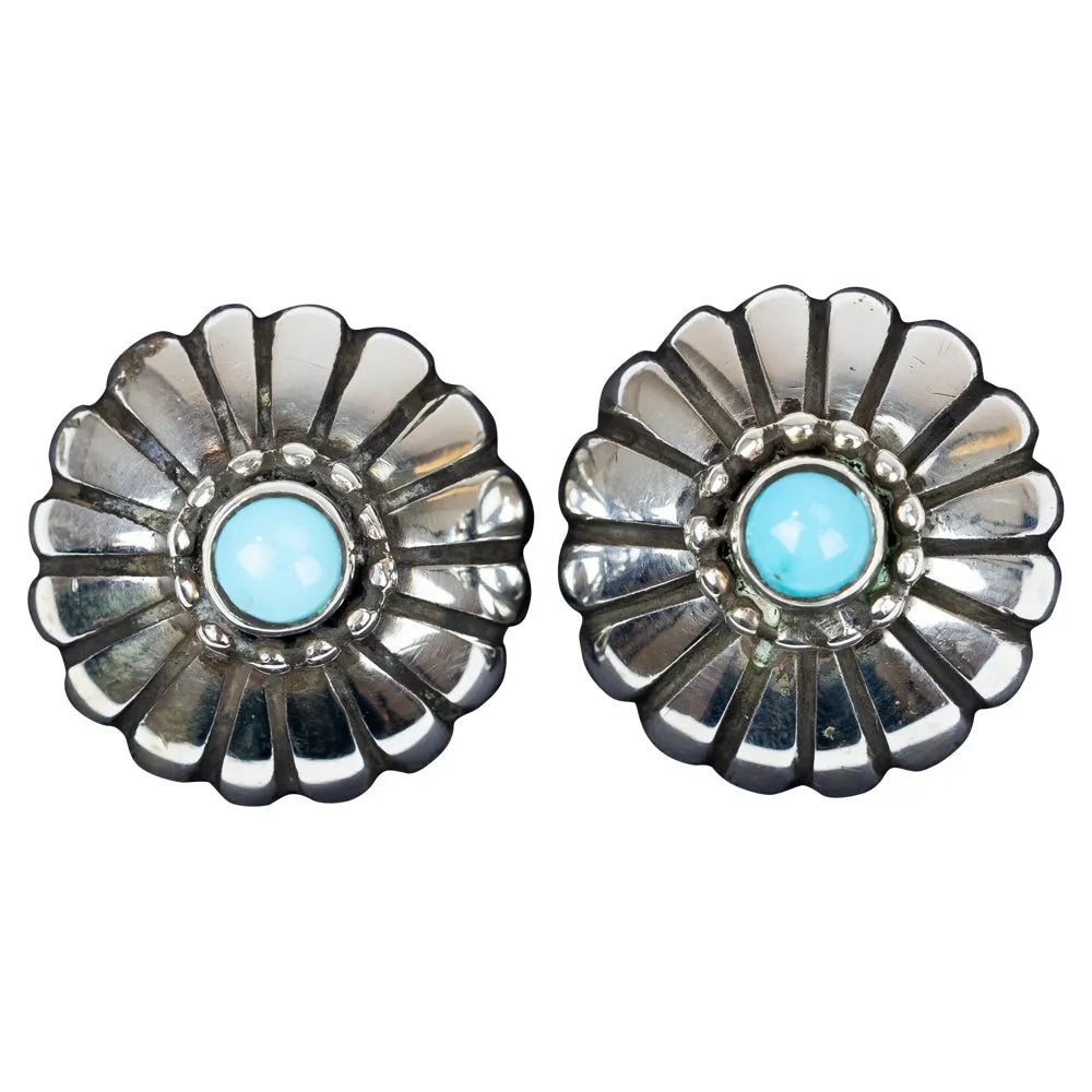 Floral silver earrings with turquoise centers on a white background
