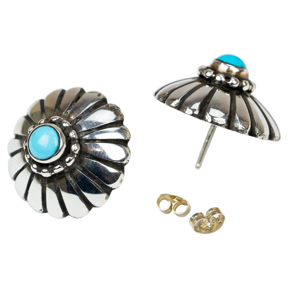 Pair of silver earrings with turquoise stones on a white background