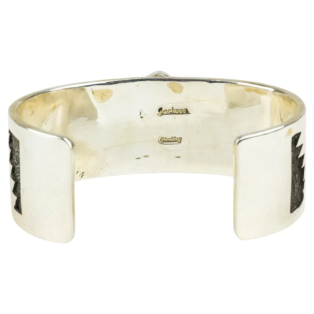 Silver cuff bracelet interior view with hallmark on a white background