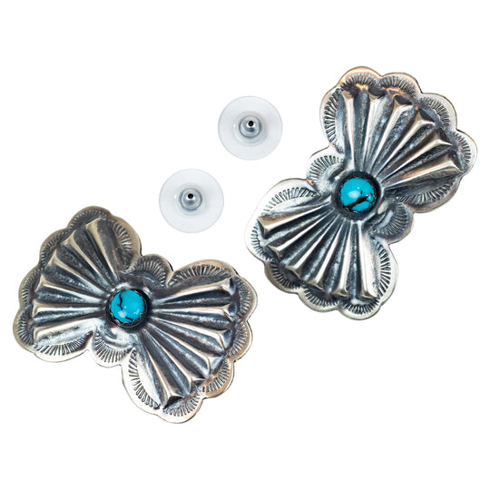 Pair of silver concho-style earrings with turquoise stones on a white background