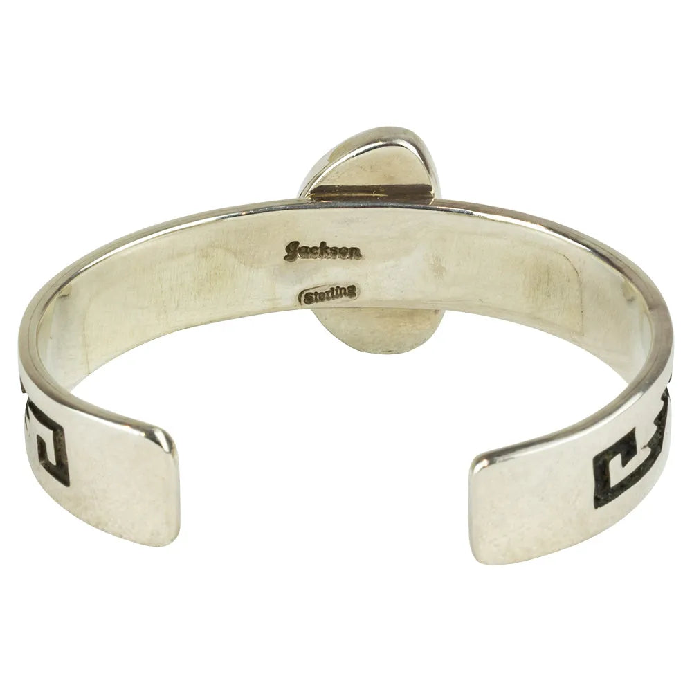 Silver bracelet with engraved hallmark on a white background