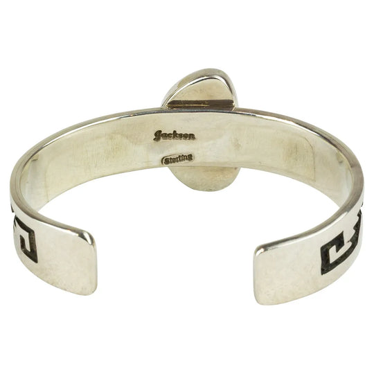 Silver bracelet with engraved hallmark on a white background