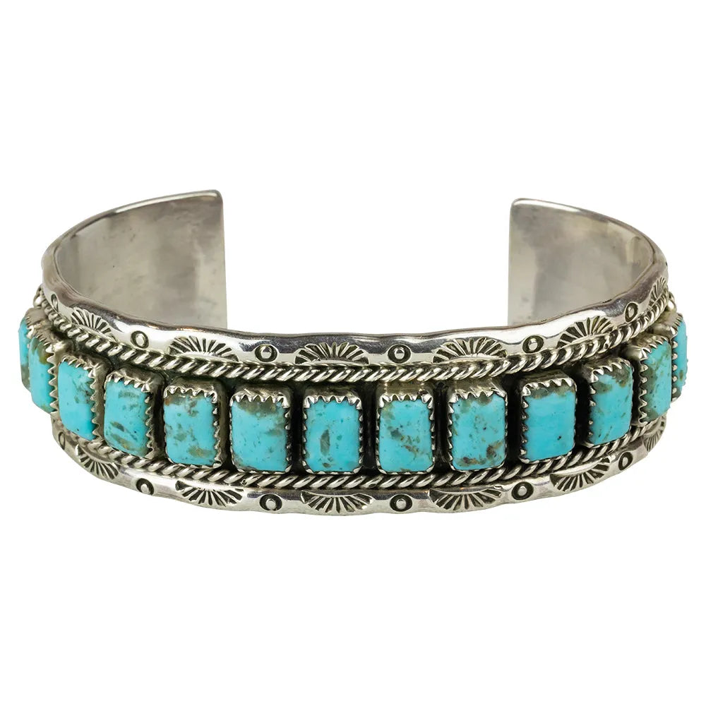 Silver bracelet with turquoise stones on a white background
