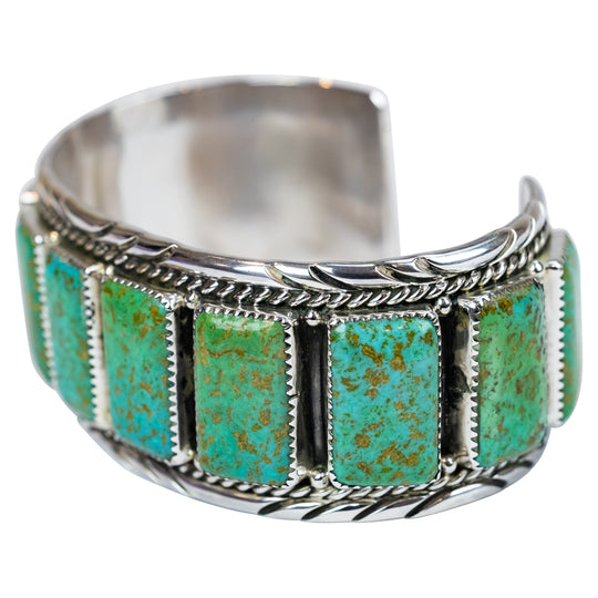 Silver ring with turquoise stones on a white background