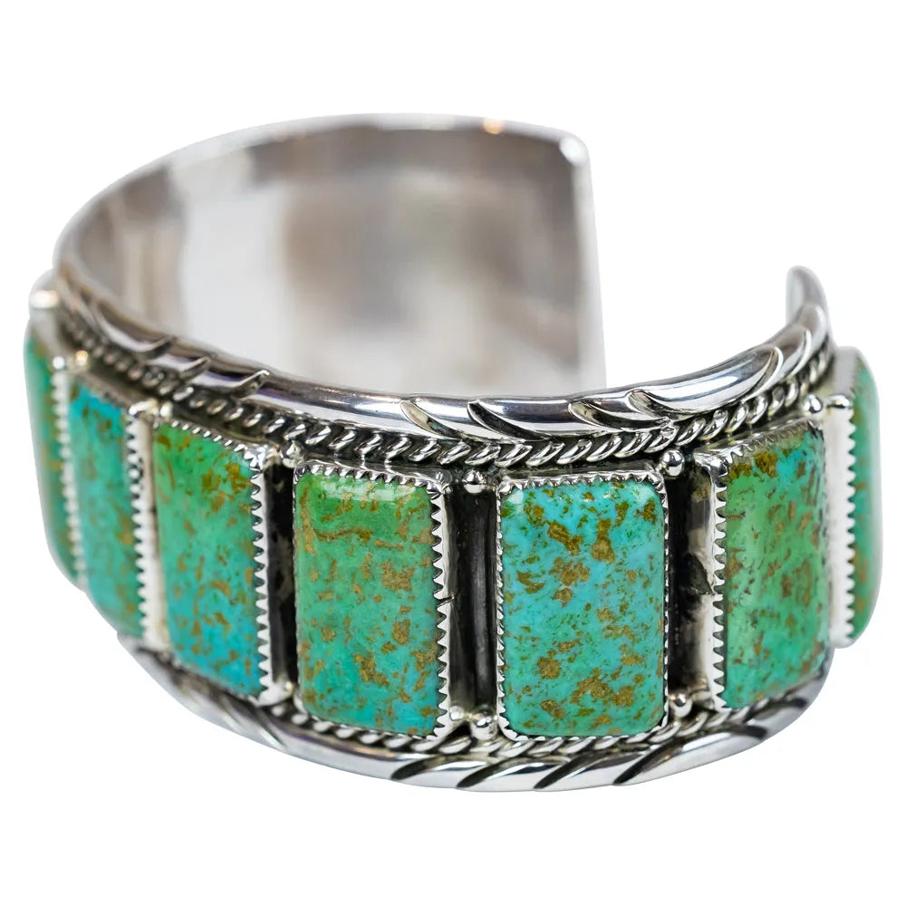 Silver ring with turquoise stones on a white background